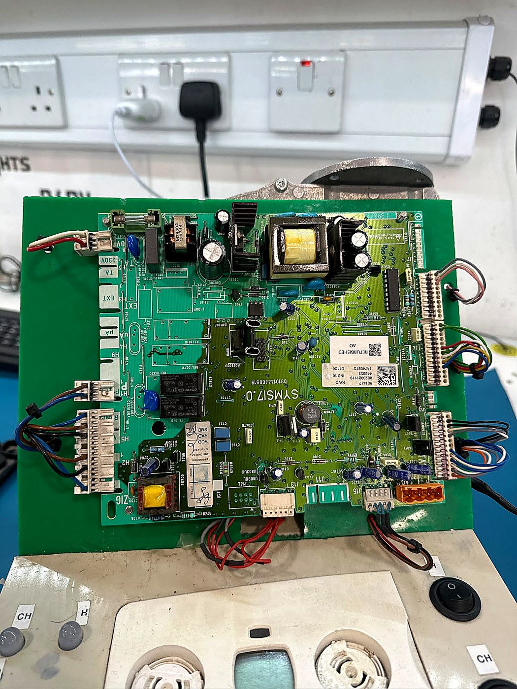 Close view of a green control PCB during bench validation